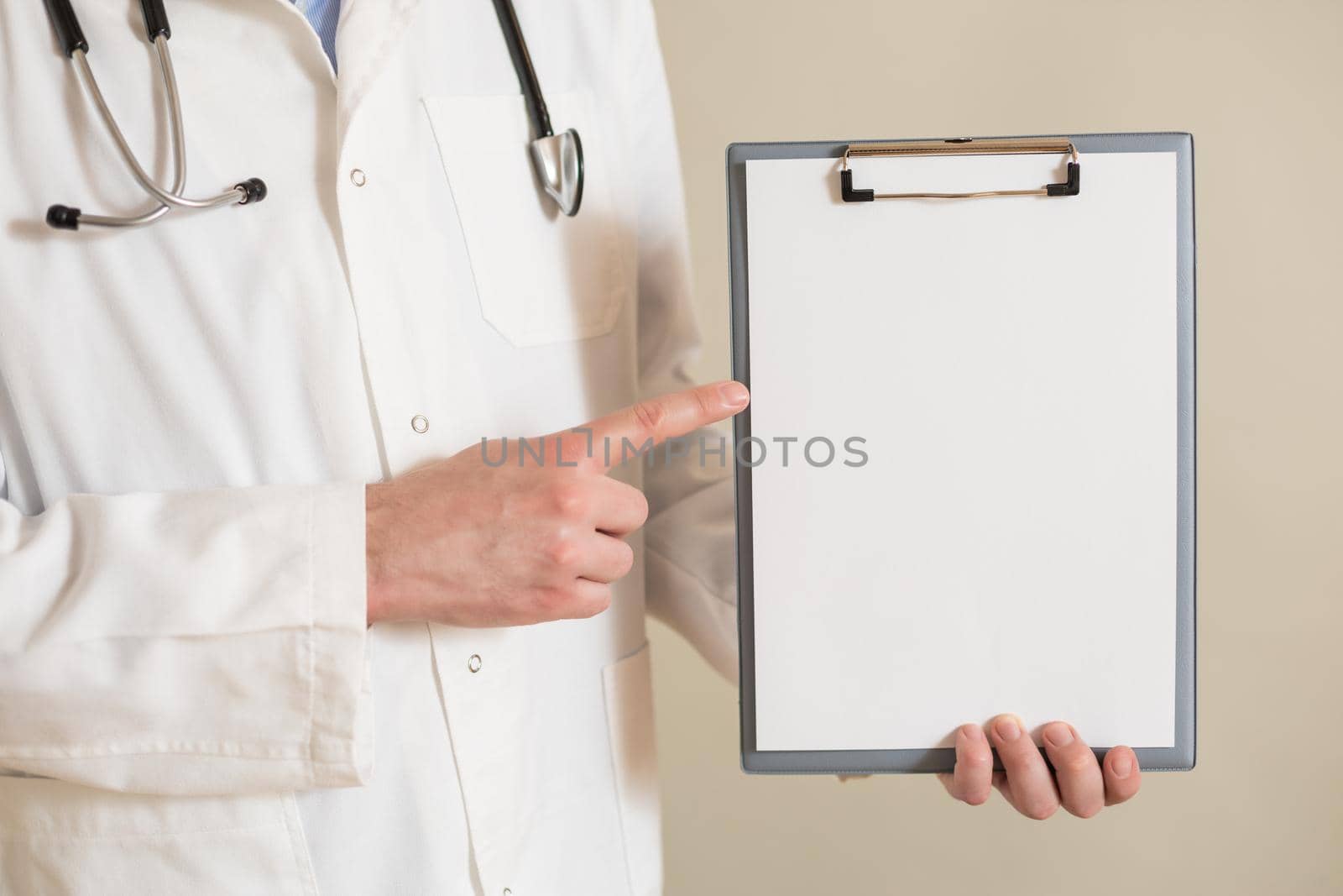 Image of male  doctor showing on clipboard.