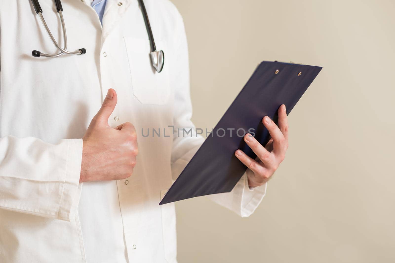 Male  doctor showing thumb up and holding documents by Bazdar