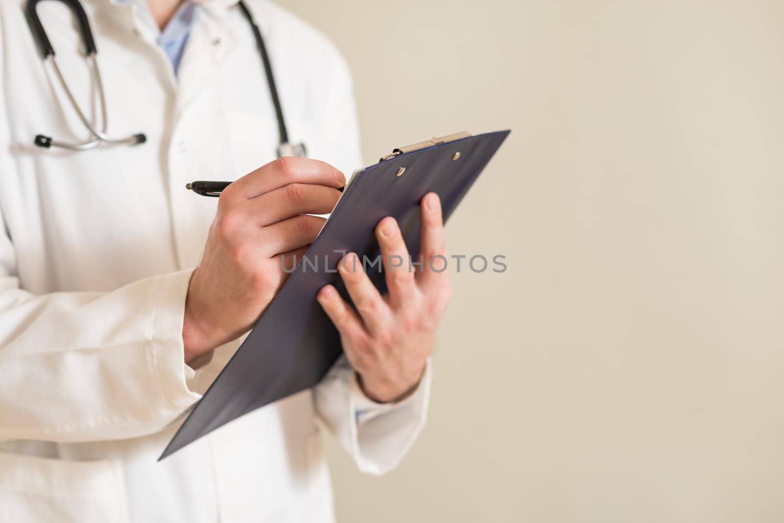 Image of male doctor writing notes.