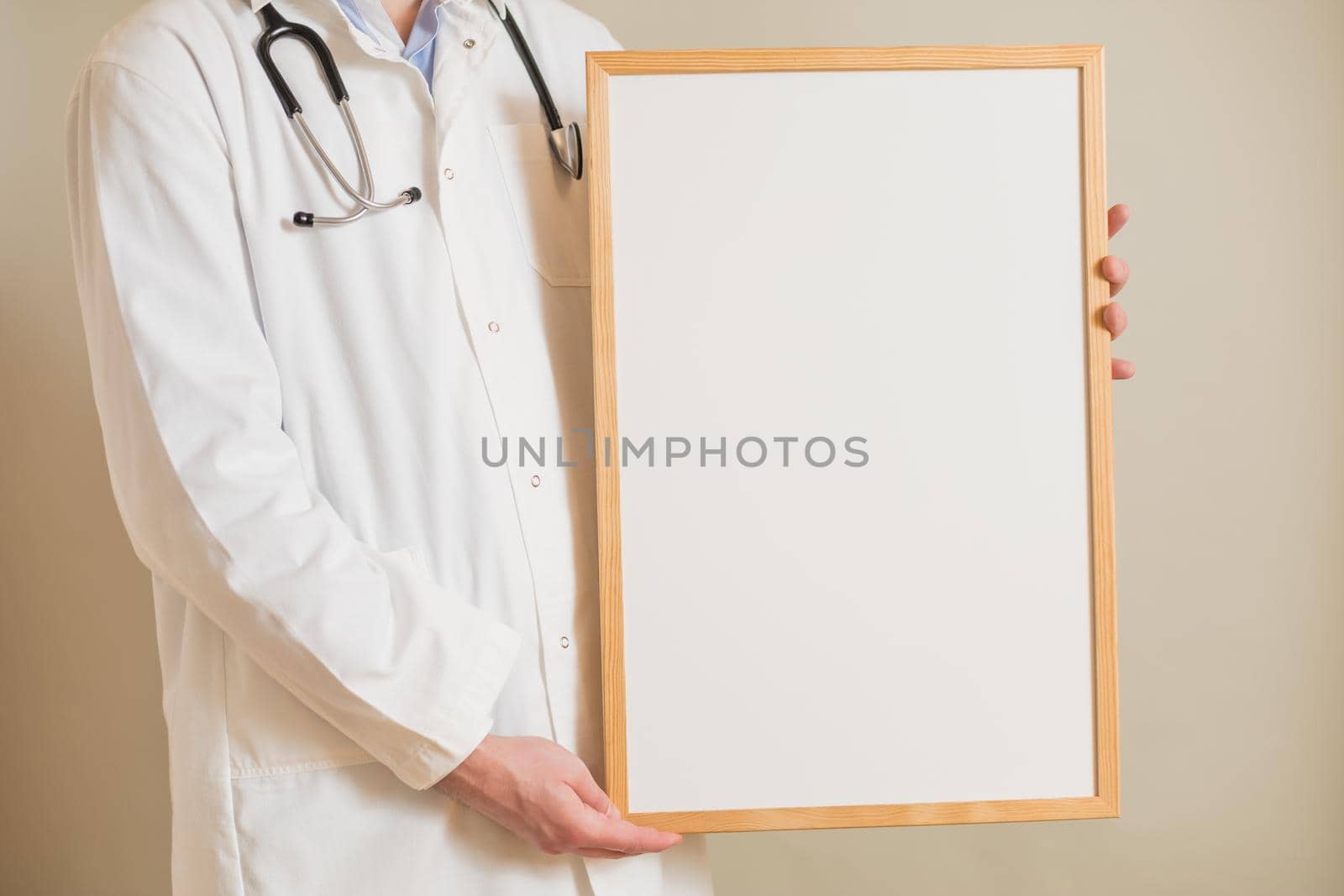 Male  doctor holding white board by Bazdar