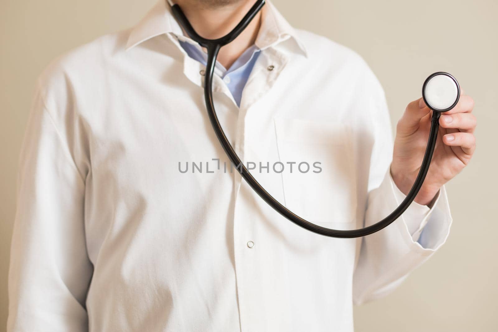 Male doctor holding stethoscope by Bazdar