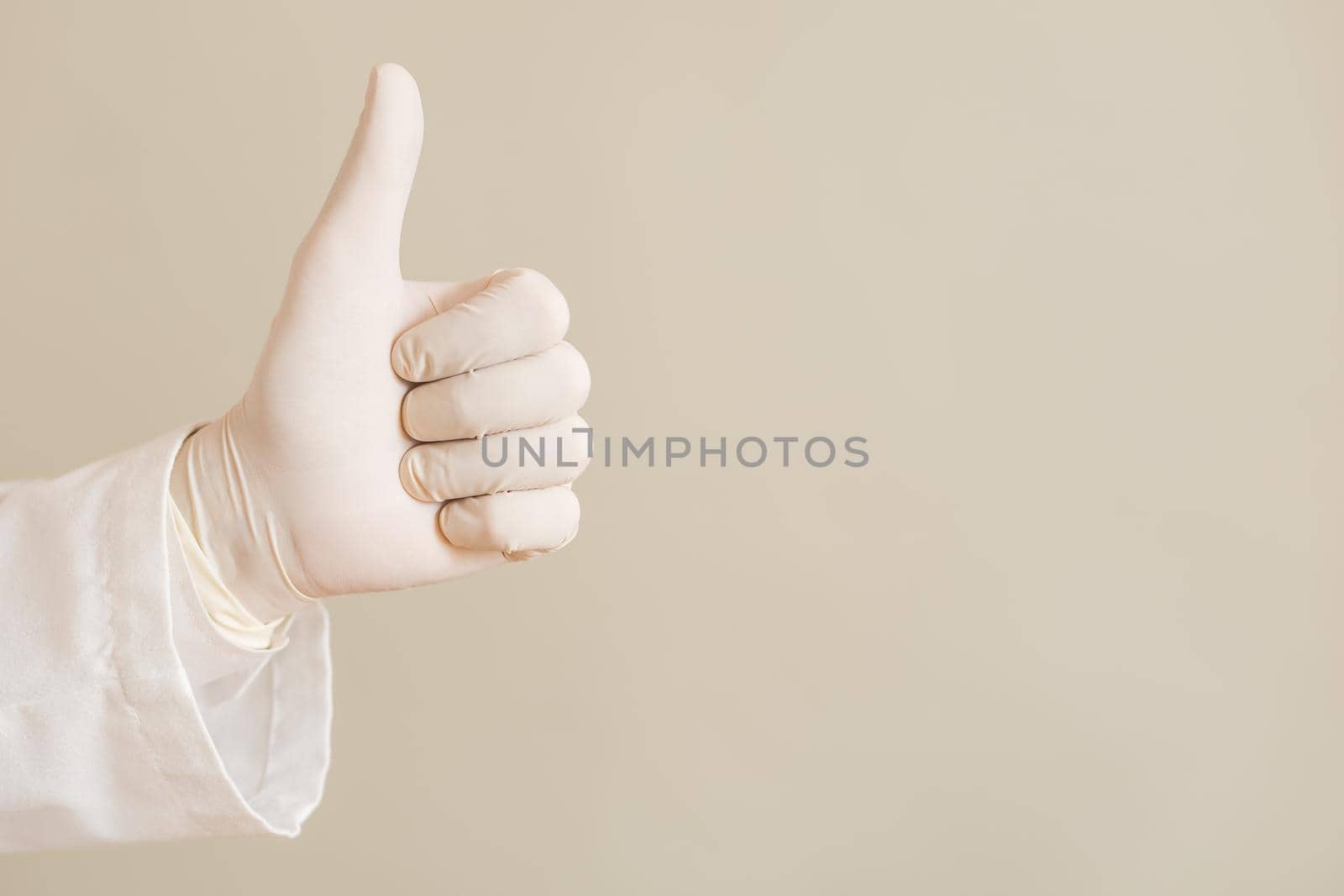 Hand in protective glove of doctor showing thumb up by Bazdar