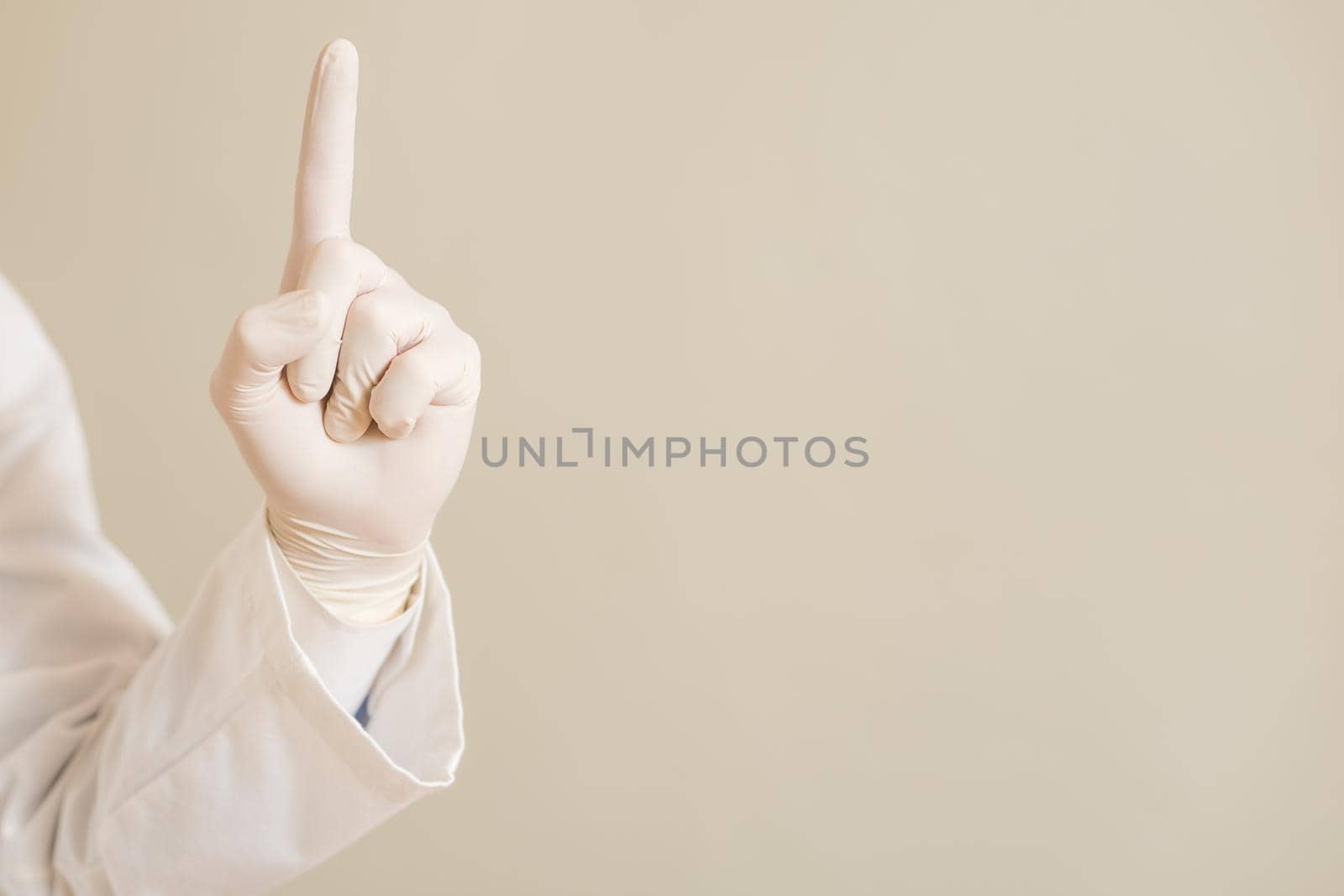 Image of close up hand in protective glove  of doctor pointing.