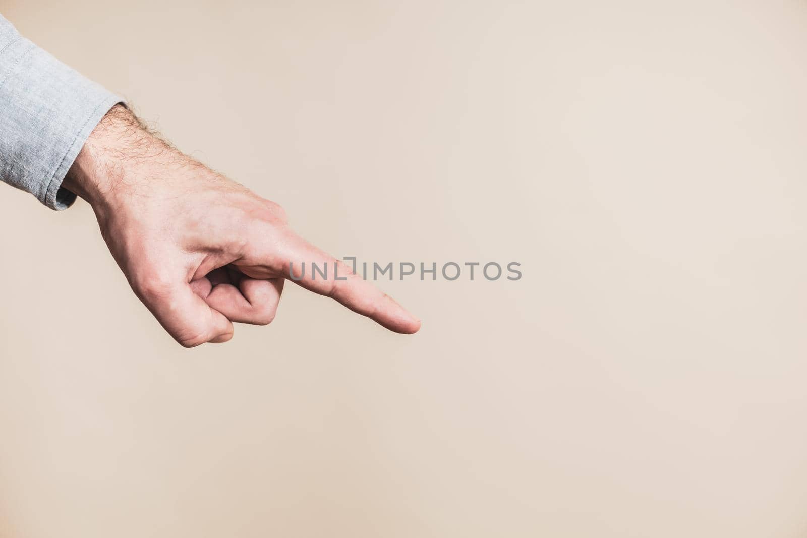 Close up image of male hand pointing.