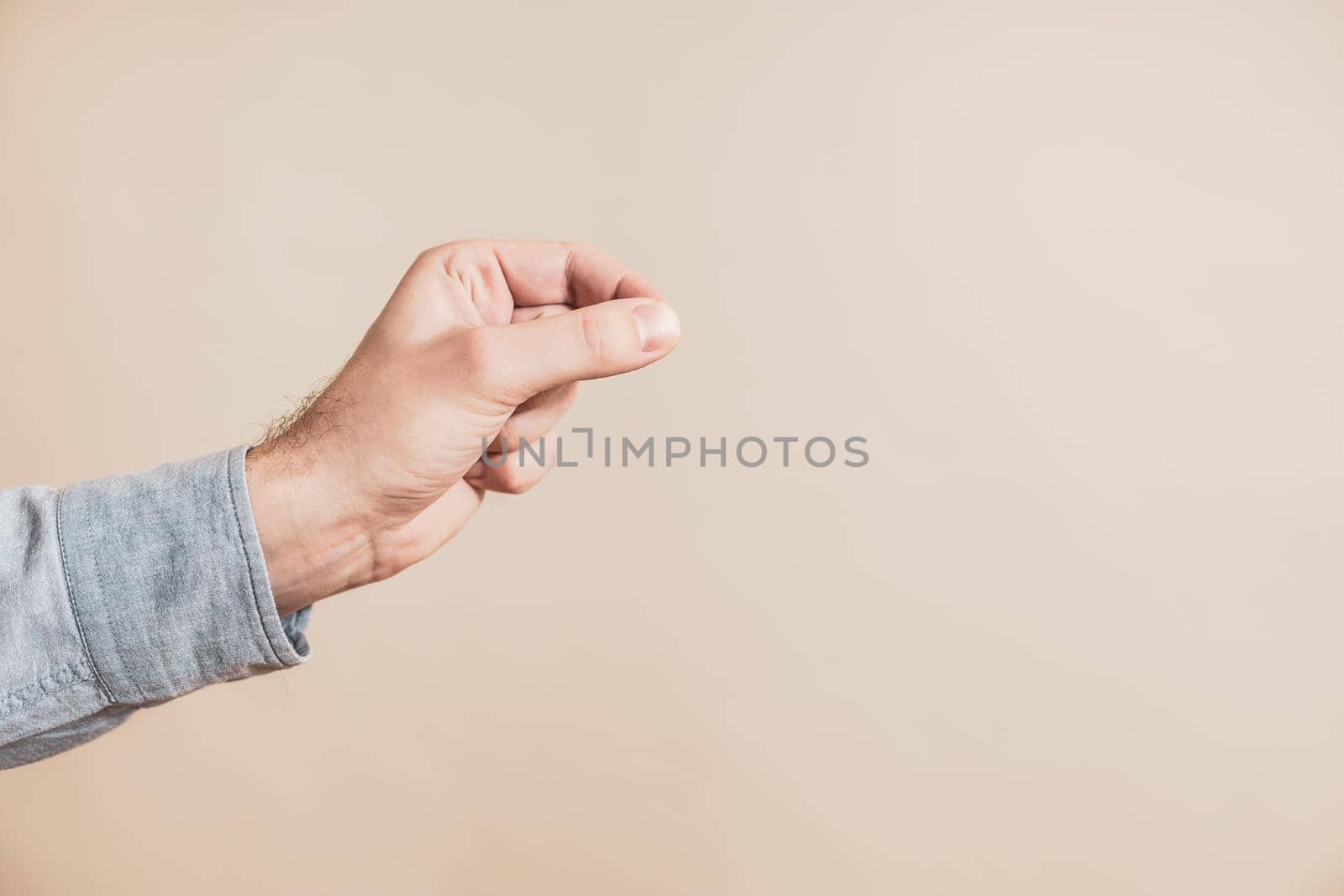 Close up image of male hand in holding gesture.