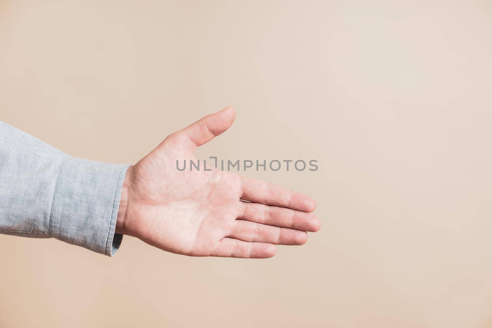 Close up image of male hand showing handshaking gesture.