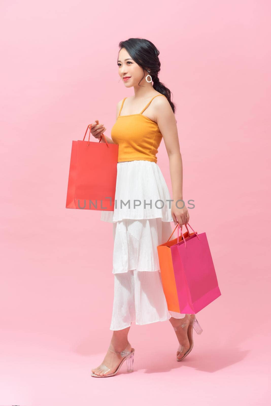 young woman with packages from shop by makidotvn