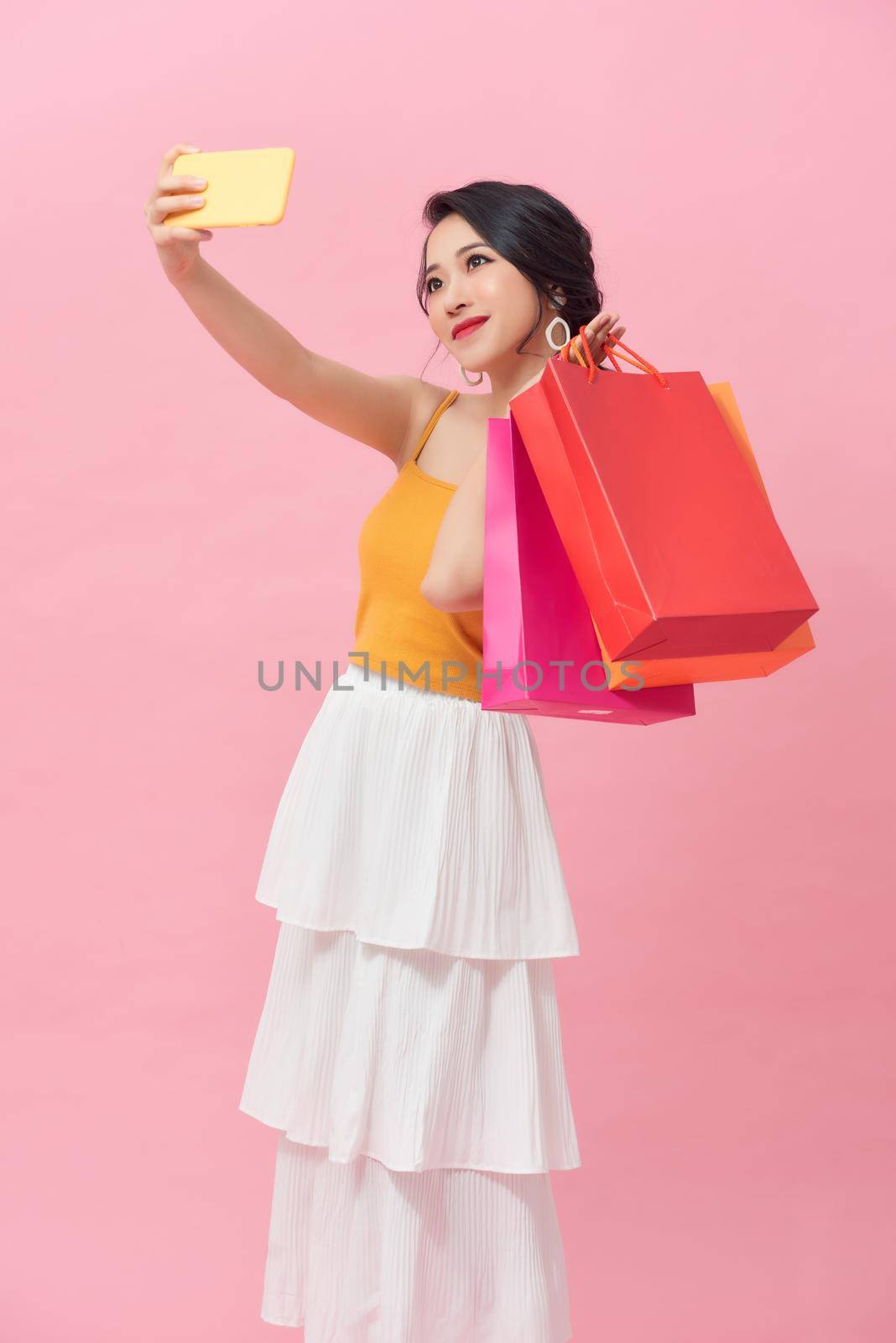 Shopping woman taking a selfie with the shopping bags