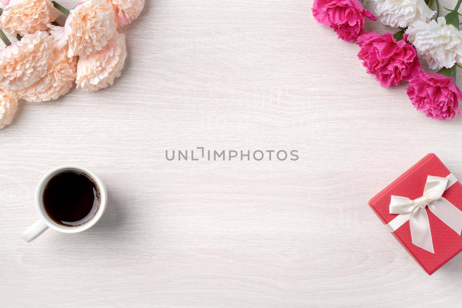 Mother's Day design concept. Top view of beautiful carnation flower and holiday gift idea with copy space.