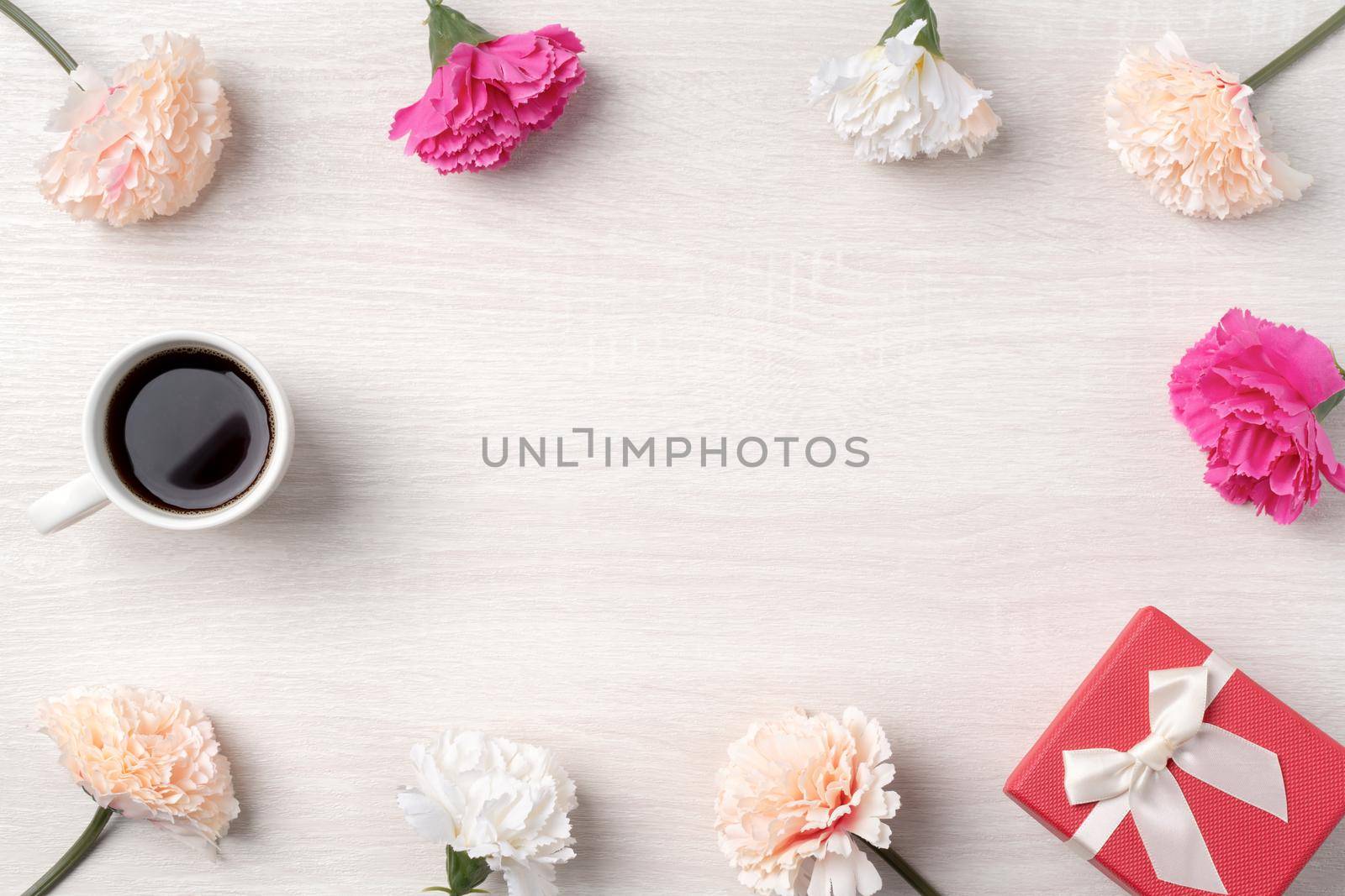 Mother's Day design concept. Top view of beautiful carnation flower and holiday gift idea with copy space.