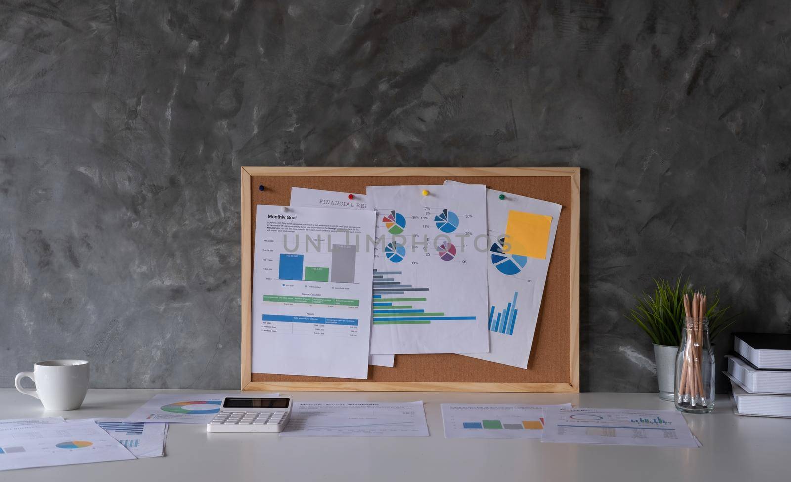 Business Workspace at home with laptop computer, financial document and office supplies on office workplace.