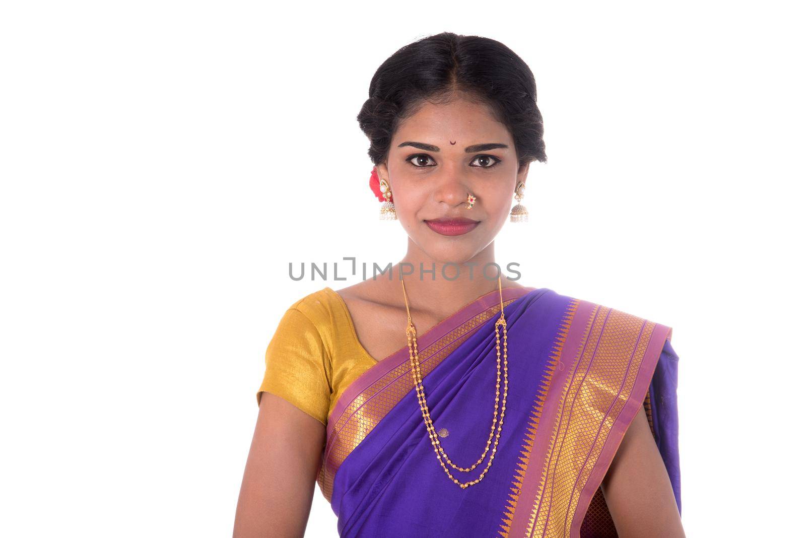 Beautiful Indian young girl posing in traditional Indian saree on white background.