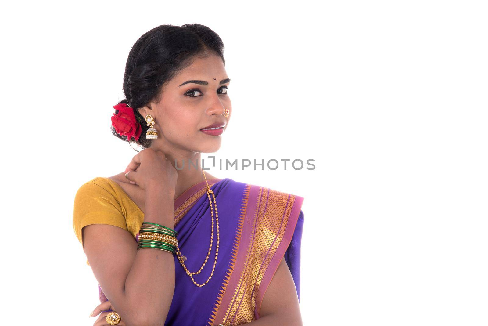 Beautiful Indian young girl posing in traditional Indian saree on white background.