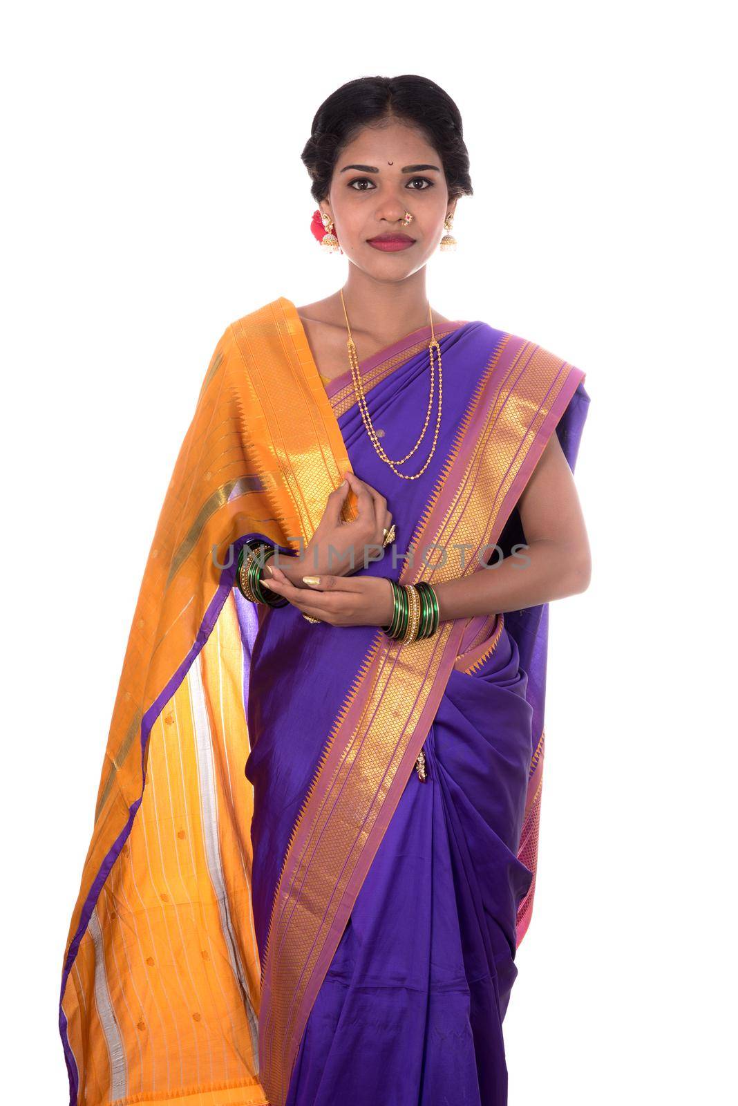 Beautiful Indian young girl posing in traditional Indian saree on white background.