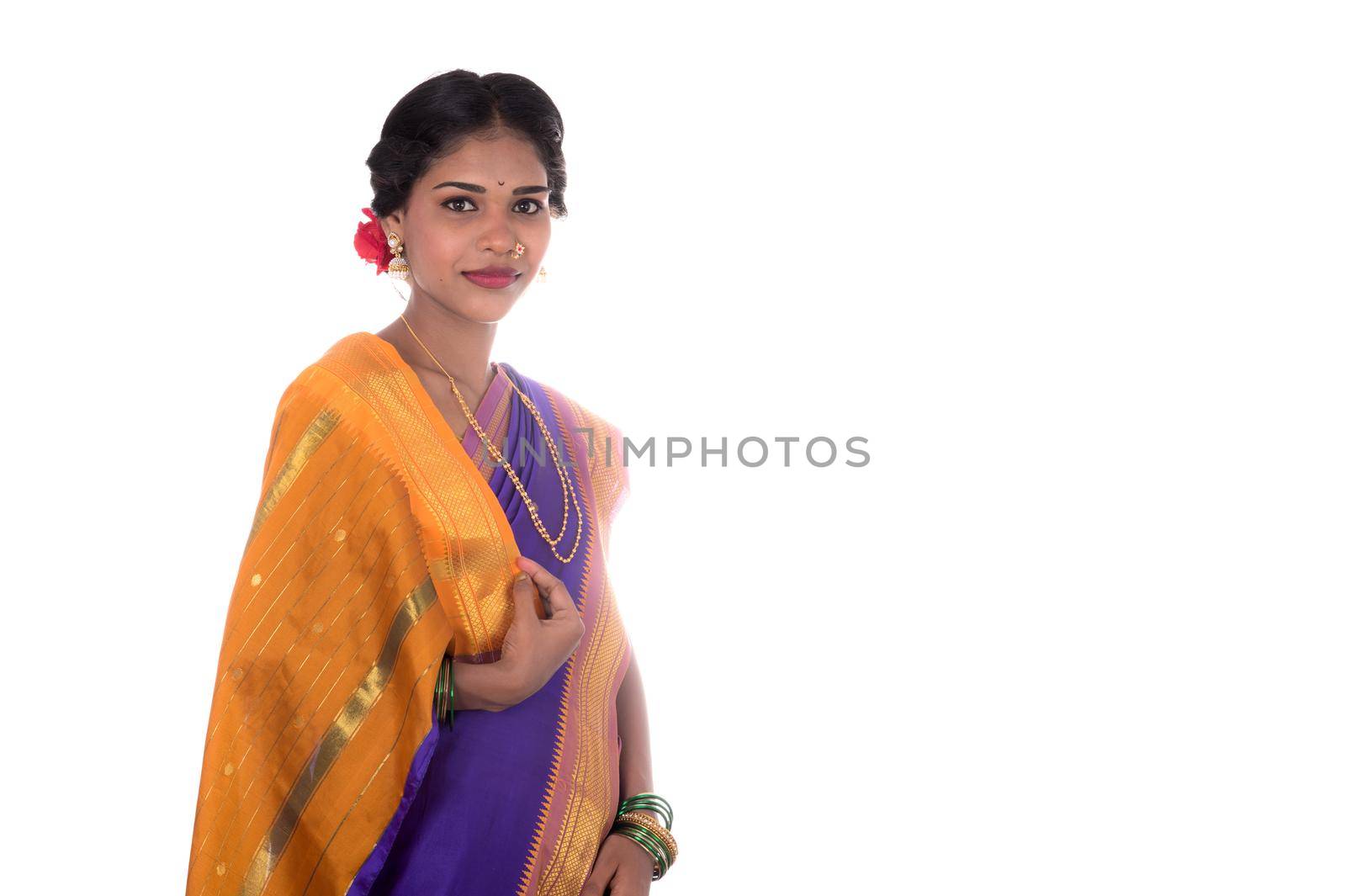 Beautiful Indian young girl posing in traditional Indian saree on white background.