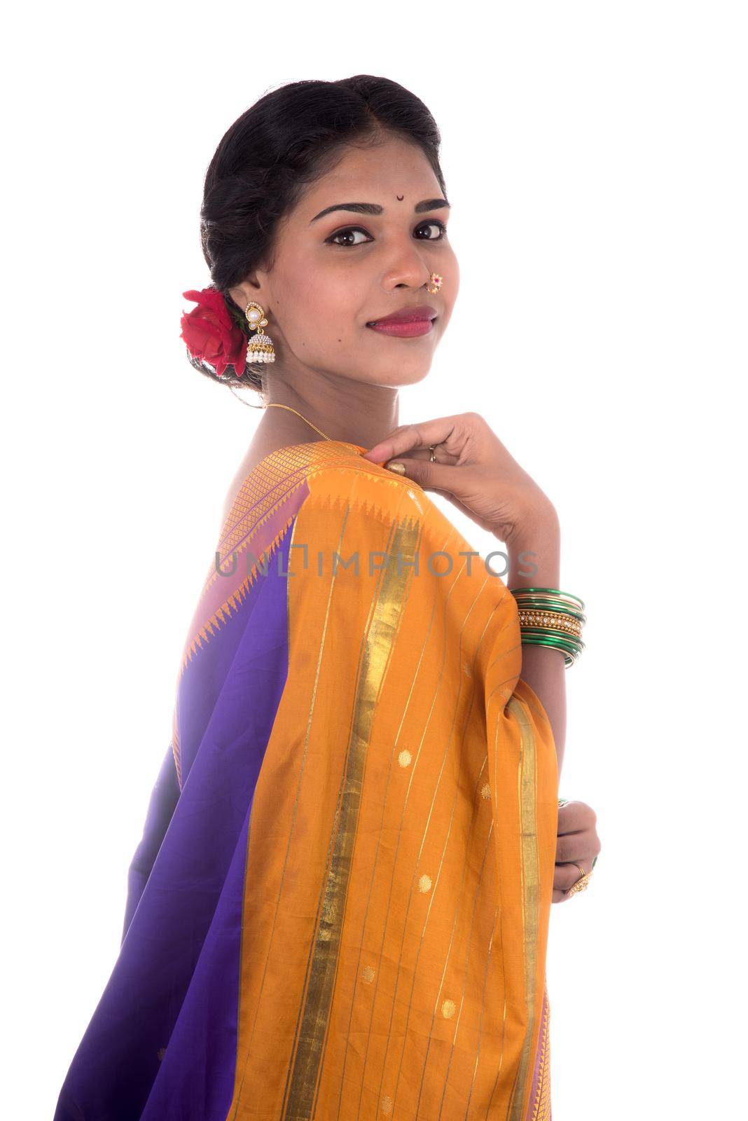 Beautiful Indian young girl posing in traditional Indian saree on white background.