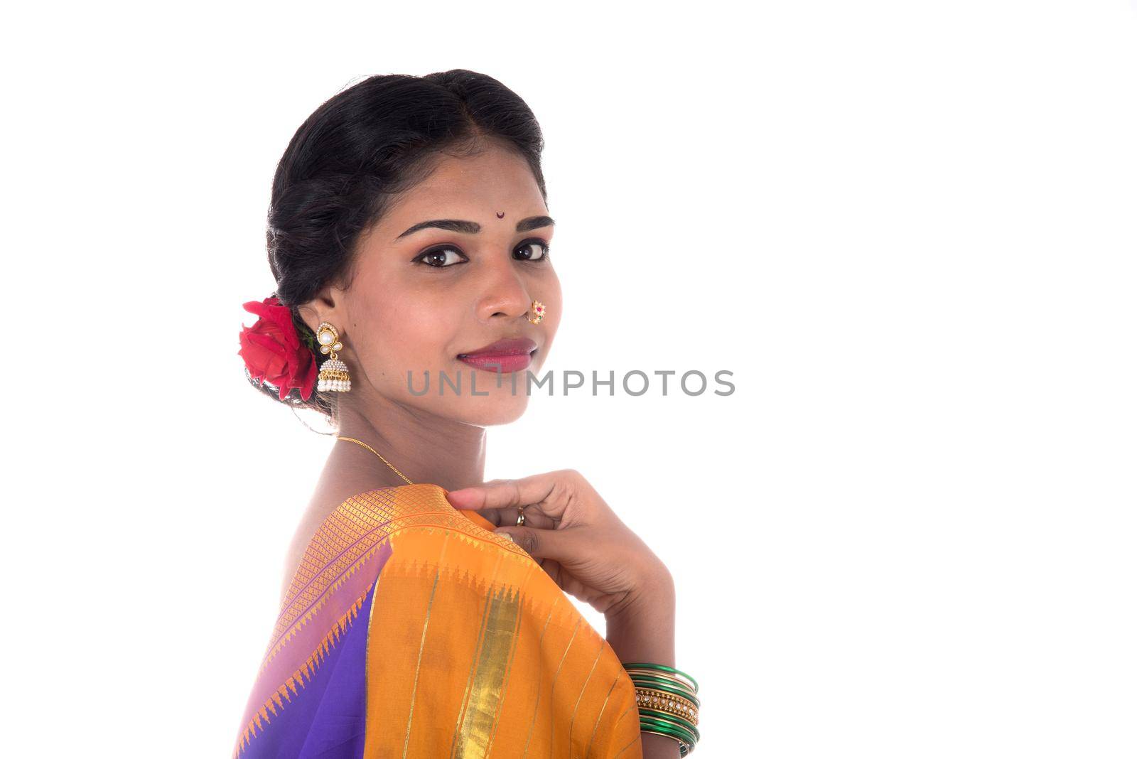 Beautiful Indian young girl posing in traditional Indian saree on white background. by DipakShelare