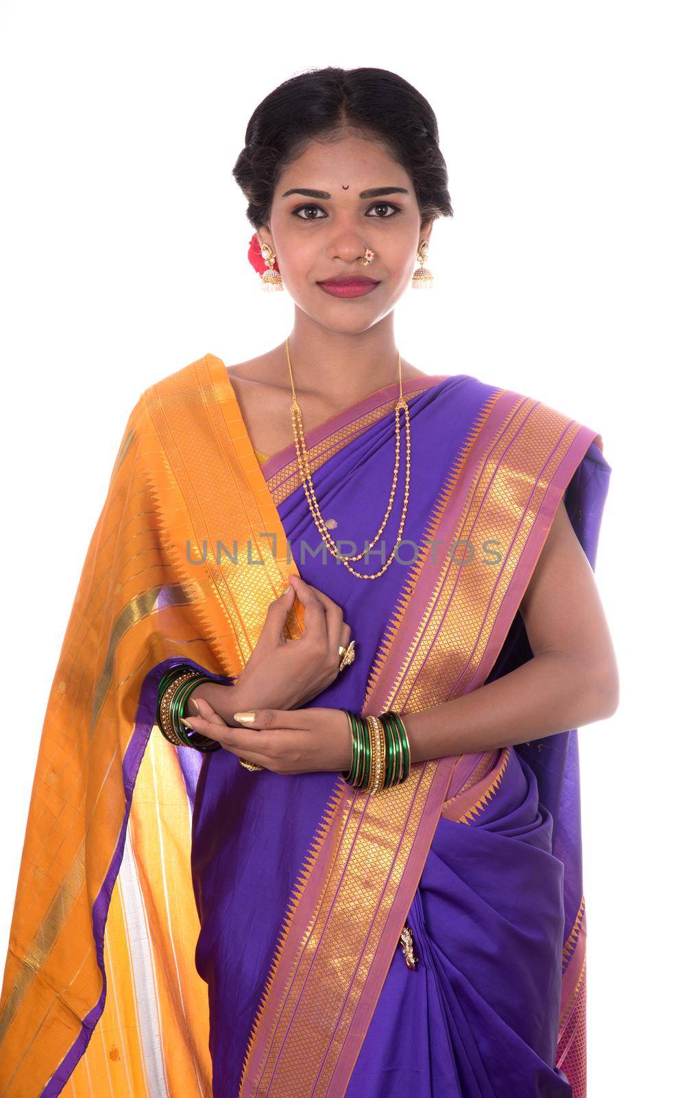 Beautiful Indian young girl posing in traditional Indian saree on white background.