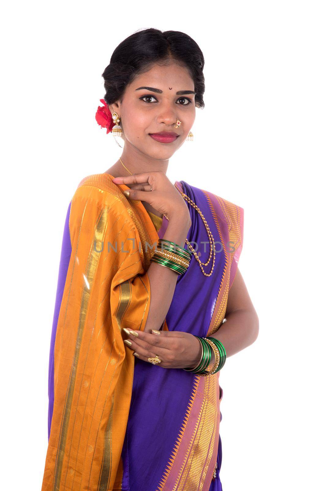 Beautiful Indian young girl posing in traditional Indian saree on white background.