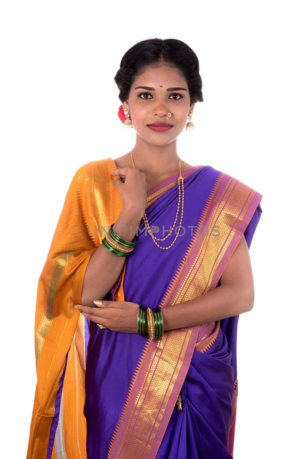 Beautiful Indian young girl posing in traditional Indian saree on white background.