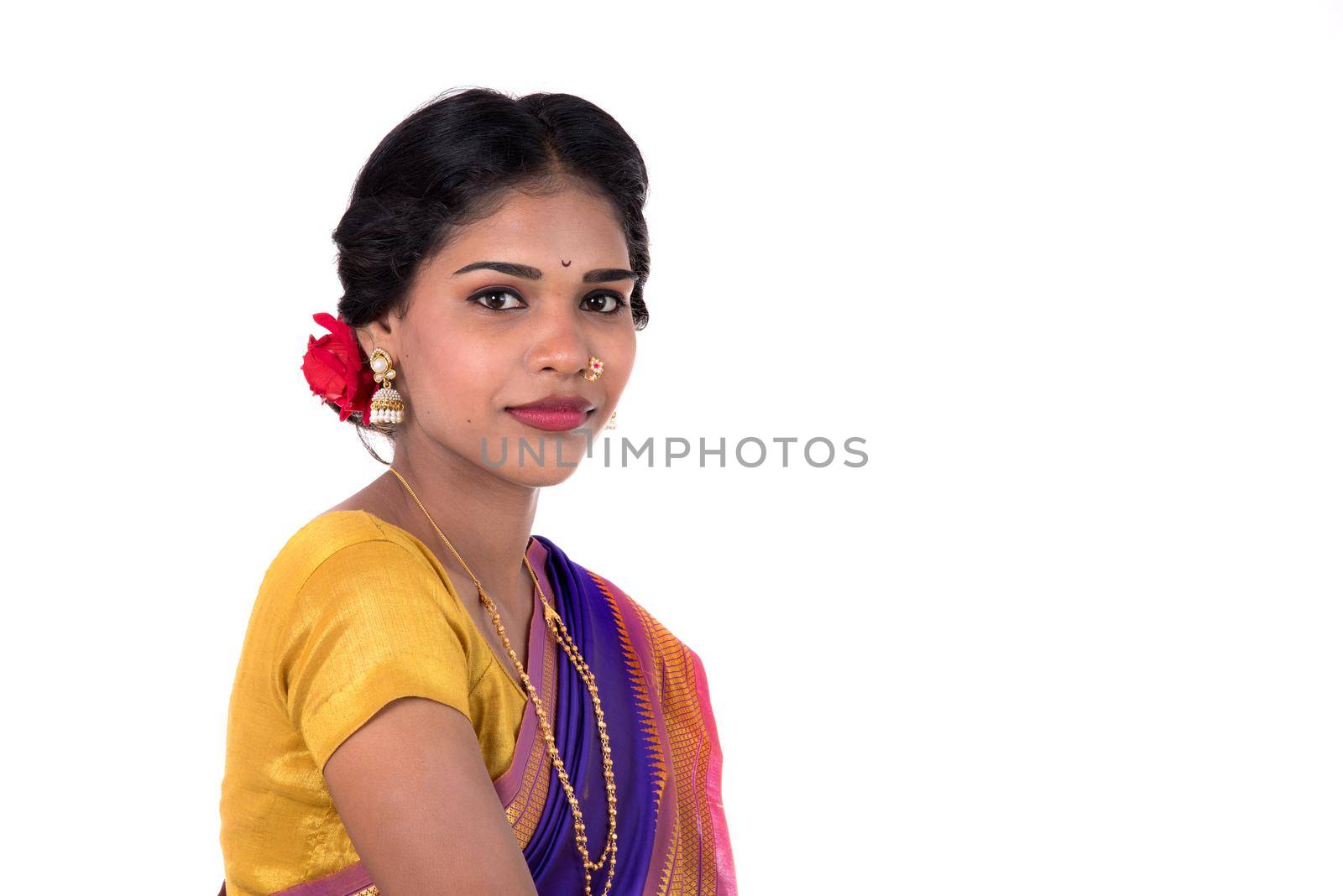 Beautiful Indian young girl posing in traditional Indian saree on white background.