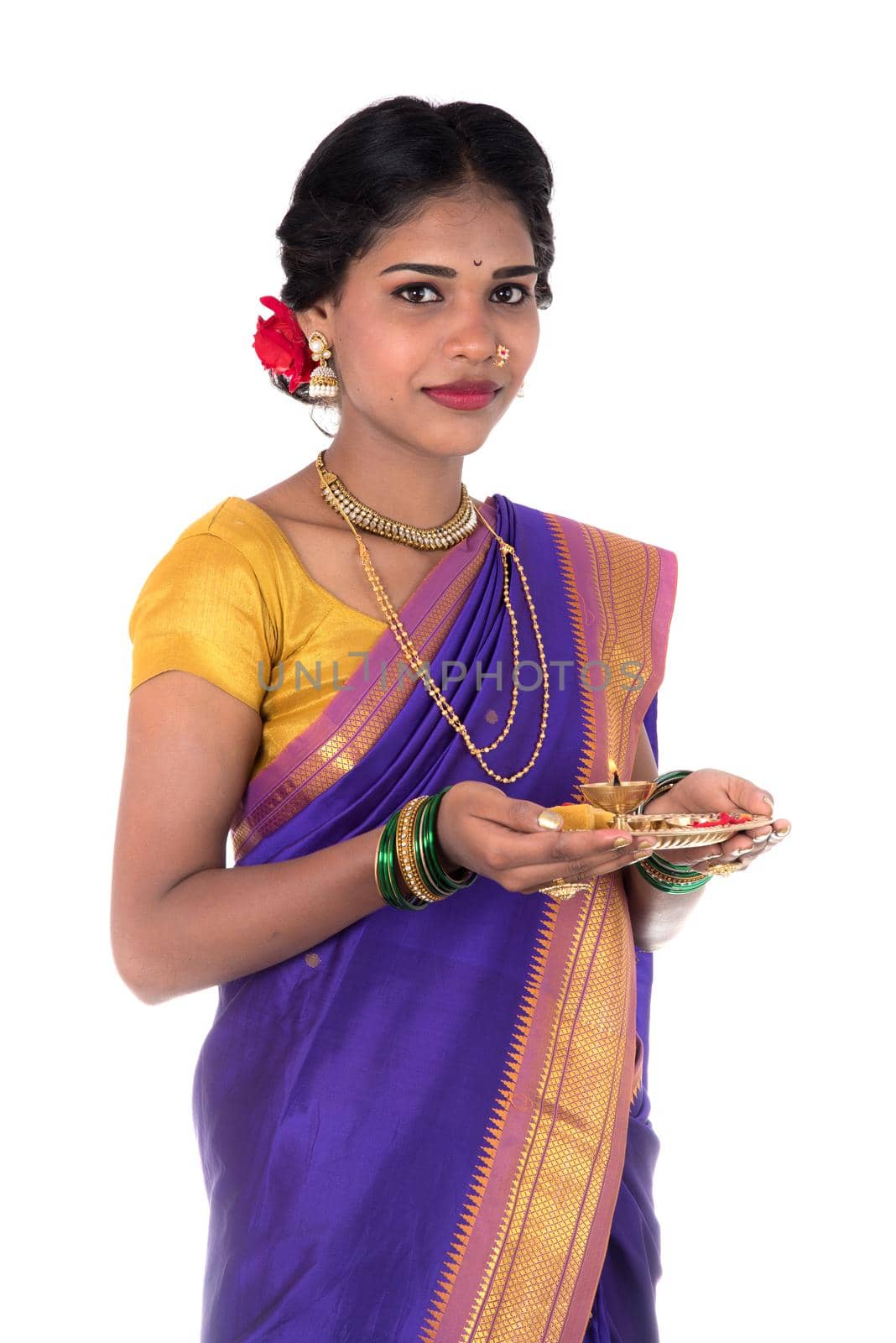 Indian woman performing worship, portrait of a beautiful young lady with pooja thali isolated on white background