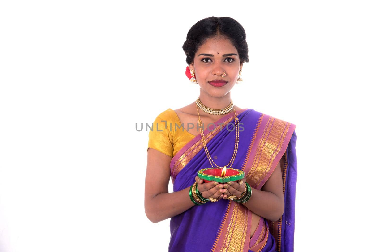 Portrait of a woman holding diya, Diwali or deepavali photo with female hands holding oil lamp during festival of light on white background