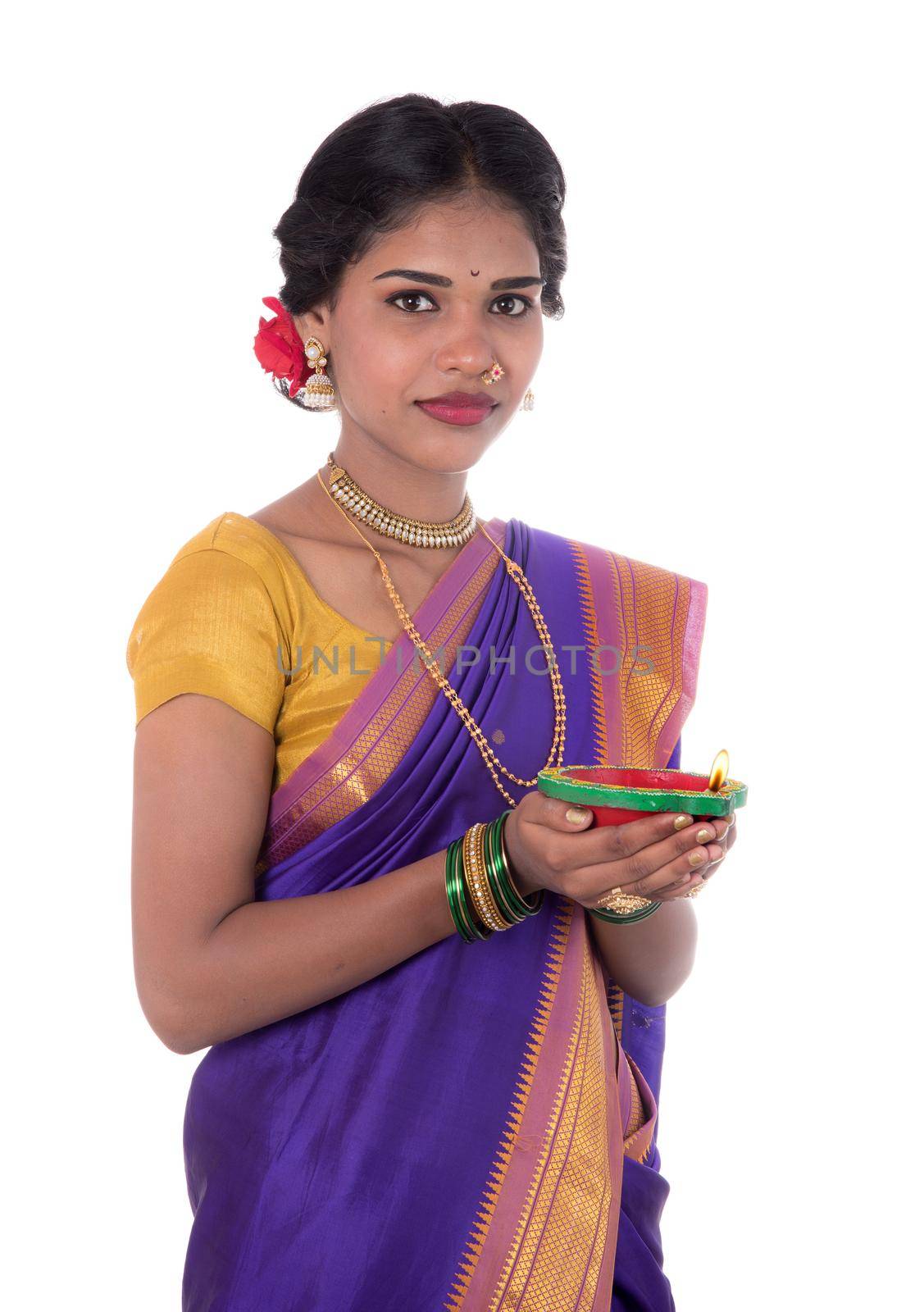 Portrait of a woman holding diya, Diwali or deepavali photo with female hands holding oil lamp during festival of light on white background