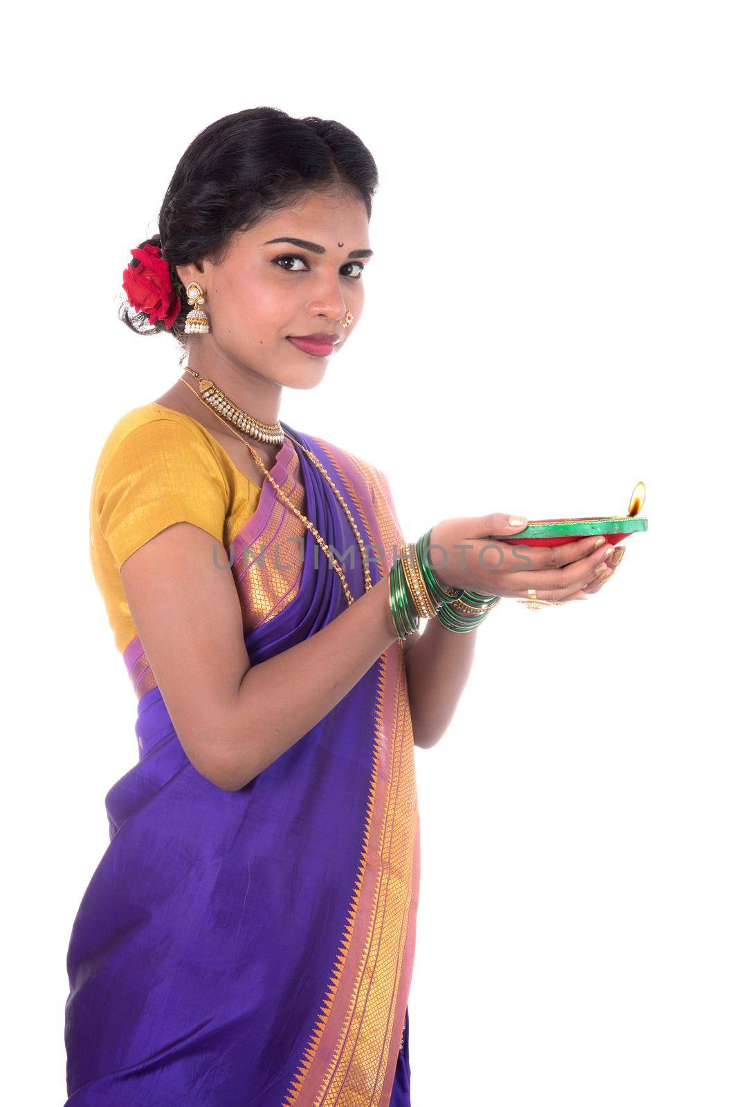 Portrait of a woman holding diya, Diwali or deepavali photo with female hands holding oil lamp during festival of light on white background