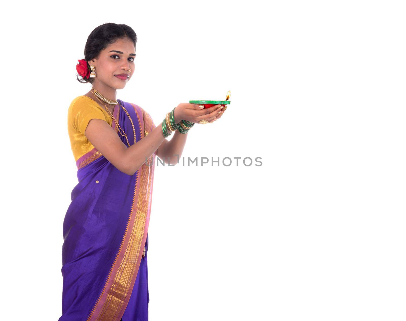 Portrait of a woman holding diya, Diwali or deepavali photo with female hands holding oil lamp during festival of light on white background