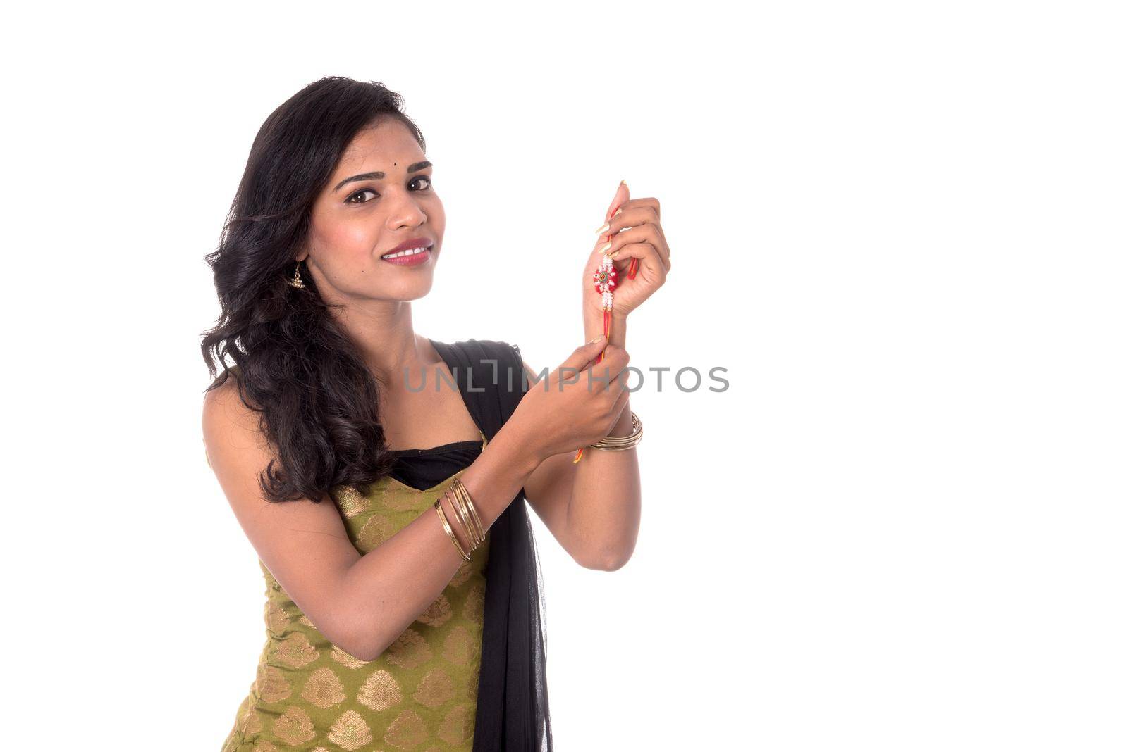 Beautiful Indian girl showing Rakhis on occasion of Raksha bandhan. Sister tie Rakhi as symbol of intense love for her brother.