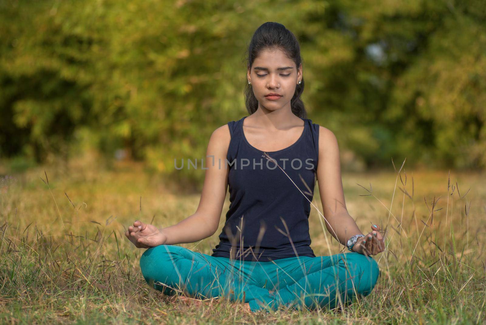 Woman do yoga outdoor. Woman exercising vital and meditation for fitness lifestyle club at the nature background. Concept Yoga. Relax in nature.