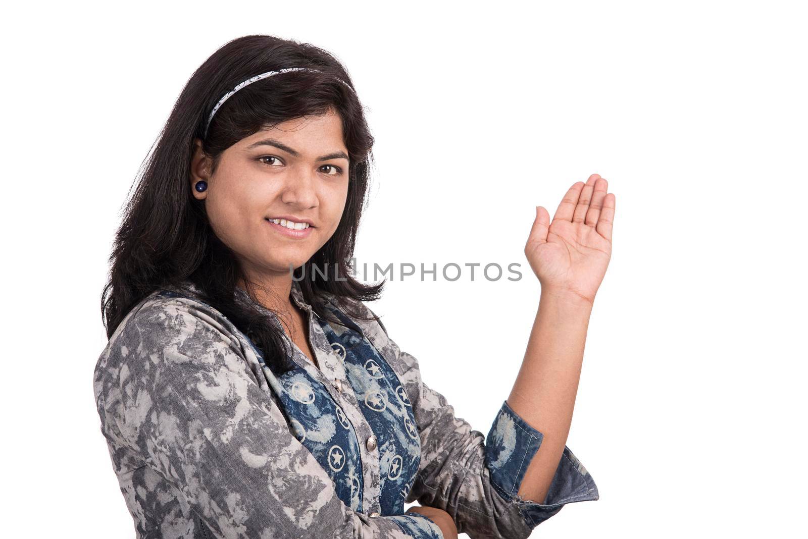 Beautiful girl showing something with happy smiling on a white background.