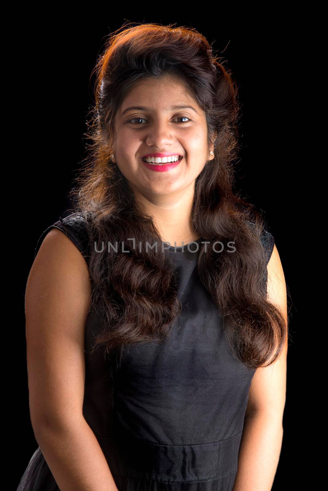 Portrait of beautiful young girl on black background