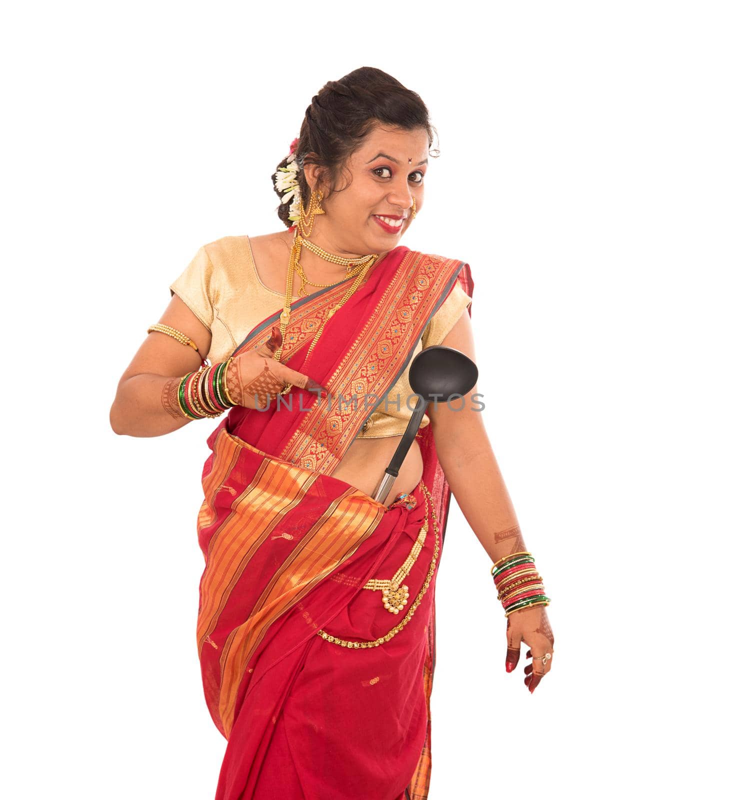 Young Traditional Indian Girl holding kitchen utensil on white background