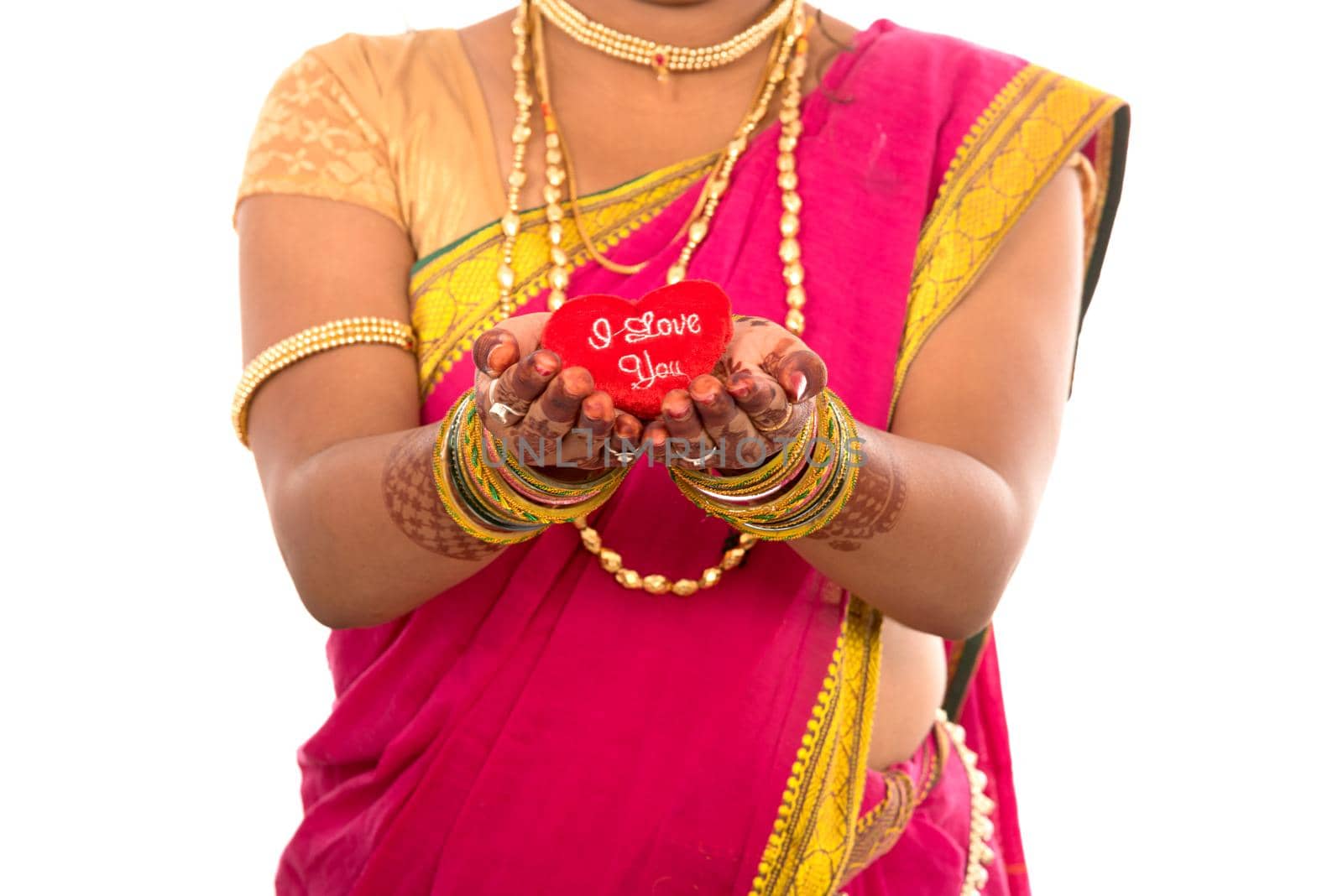 Traditional Beautiful Indian young girl in saree posing with Heart on white background