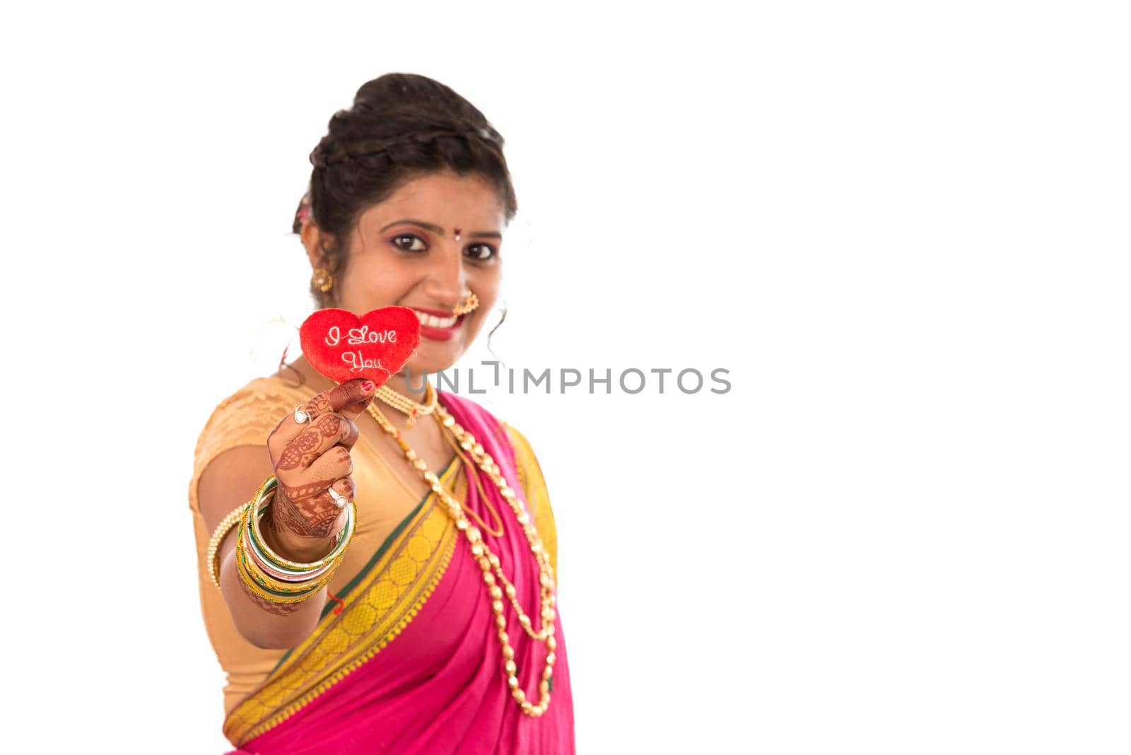 Traditional Beautiful Indian young girl in saree posing with Heart on white background by DipakShelare