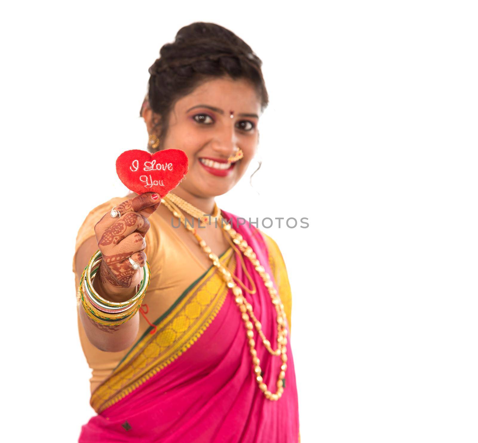 Traditional Beautiful Indian young girl in saree posing with Heart on white background by DipakShelare