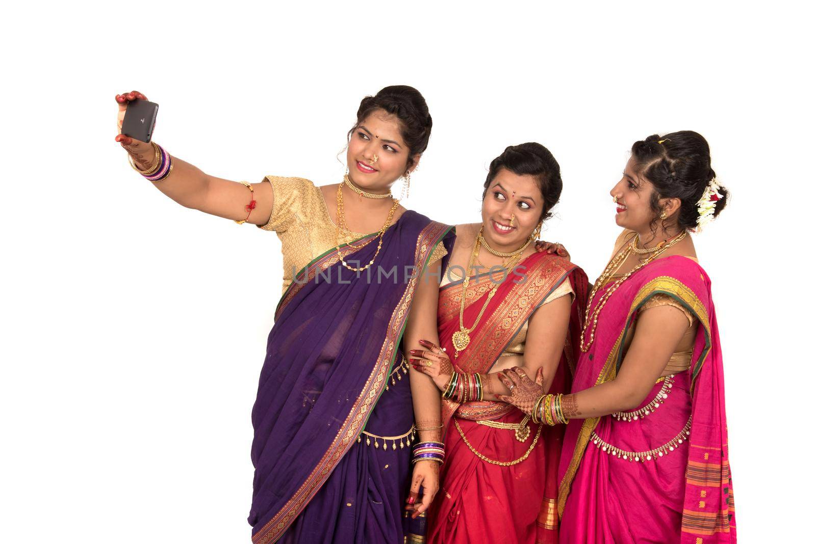 Indian traditional girls taking selfie with smartphone on white background