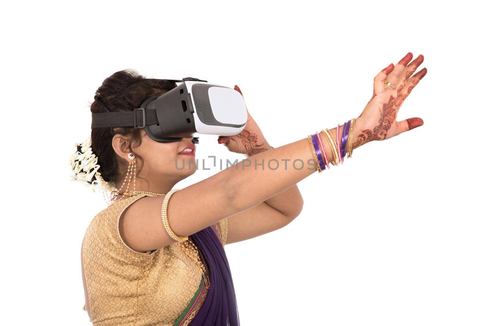 Indian traditional young woman in saree looking though VR device by DipakShelare