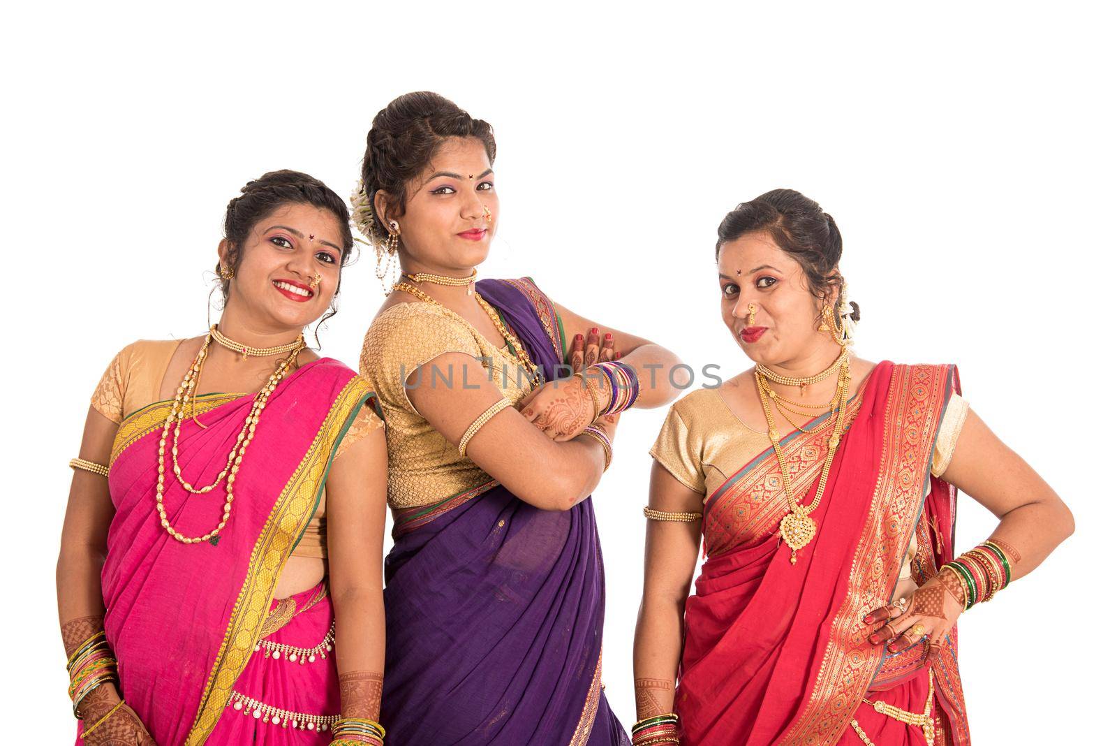 Traditional Beautiful Indian young girls in saree posing on white background by DipakShelare