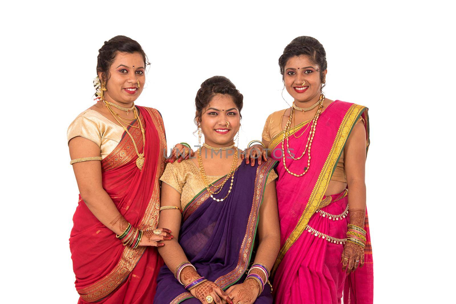 Traditional Beautiful Indian young girls in saree posing on white background by DipakShelare