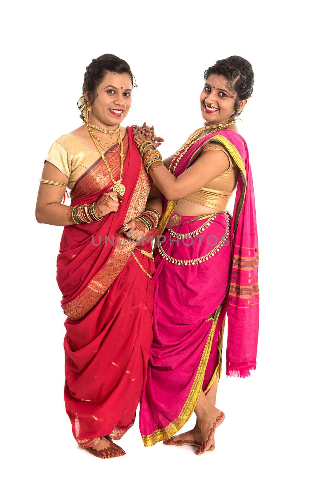 Traditional Beautiful Indian young girls in saree posing on white background by DipakShelare