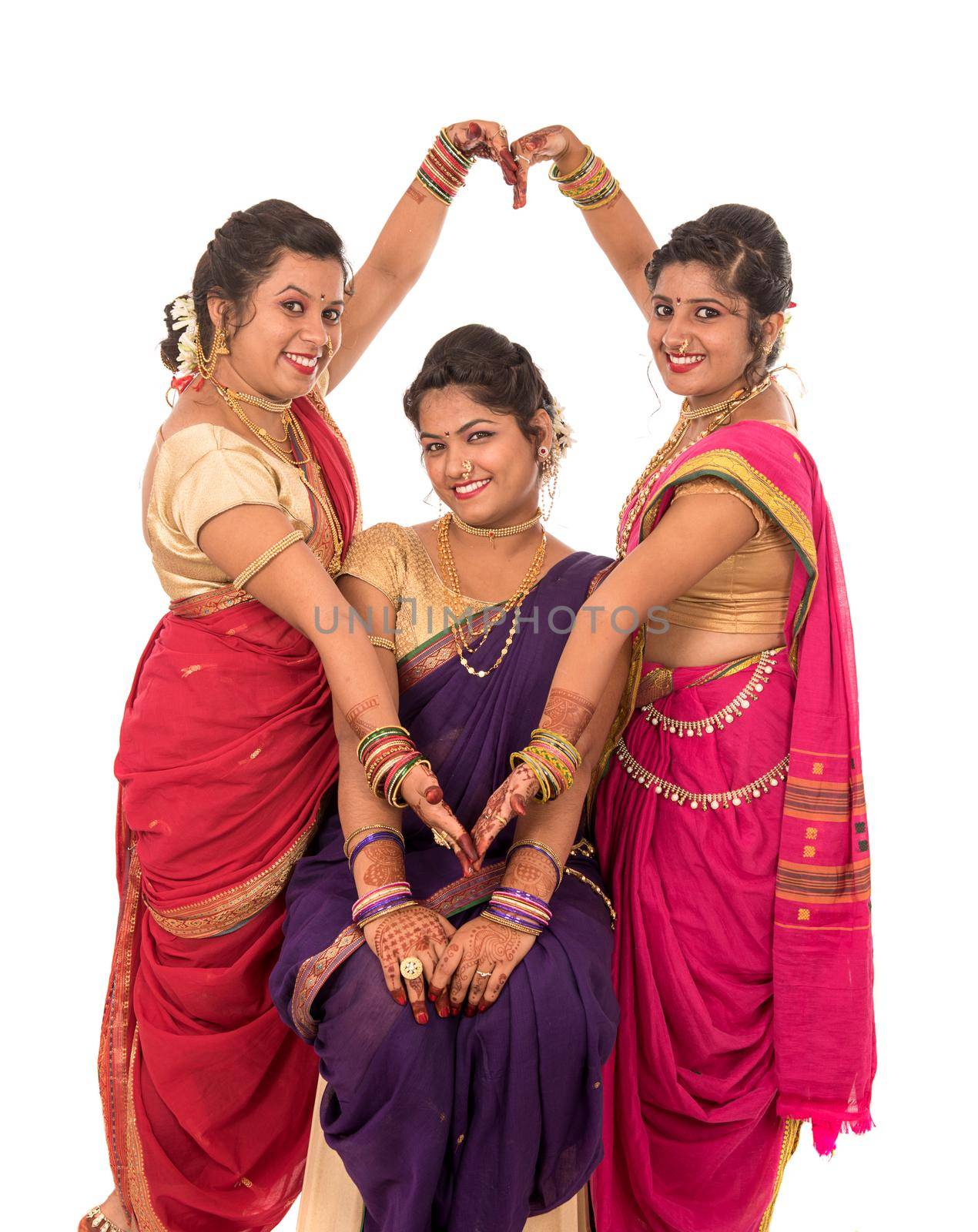 Traditional Beautiful Indian young girls in saree posing on white background by DipakShelare