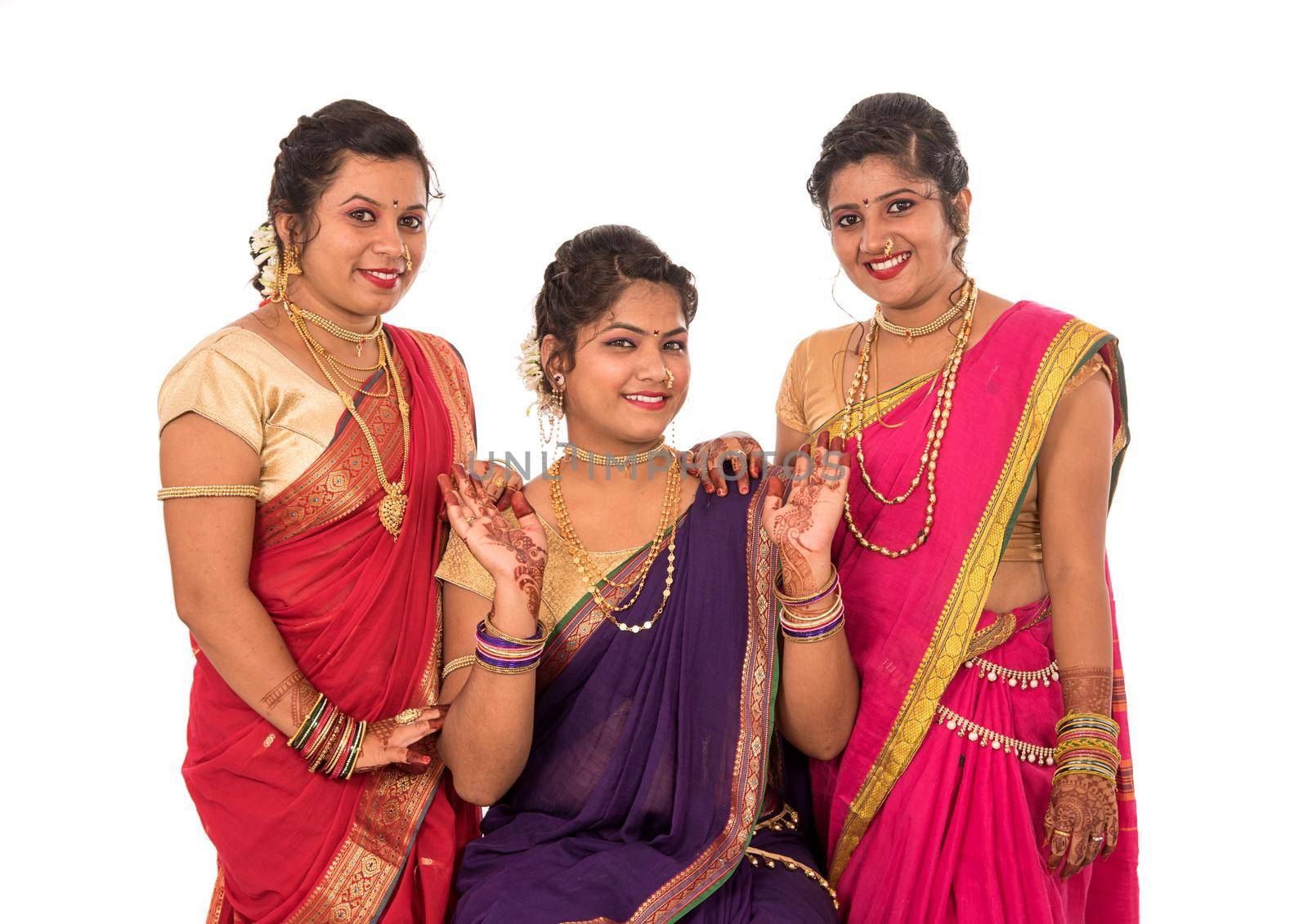 Traditional Beautiful Indian young girls in saree posing on white background by DipakShelare