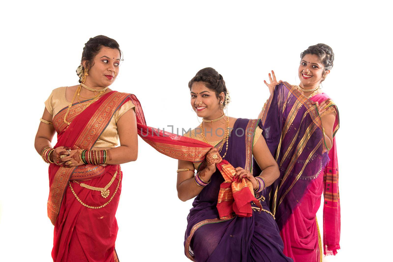 Traditional Beautiful Indian young girls in saree posing on white background by DipakShelare