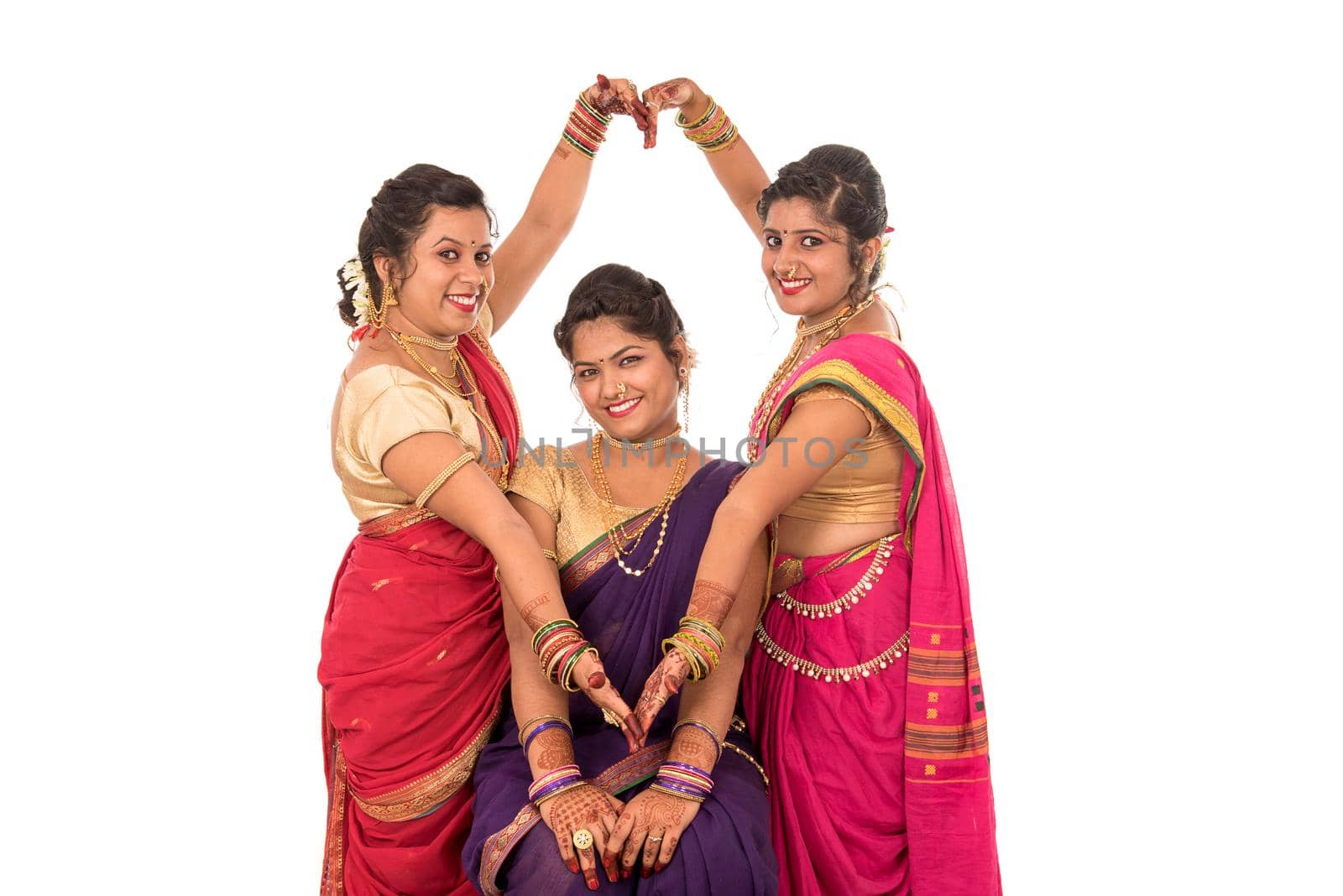 Traditional Beautiful Indian young girls in saree posing on white background by DipakShelare