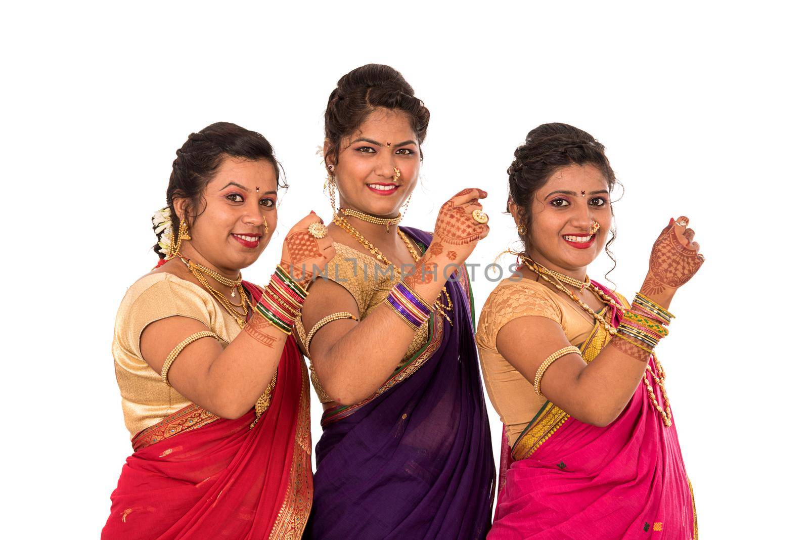 Traditional Beautiful Indian young girls in saree posing on white background by DipakShelare