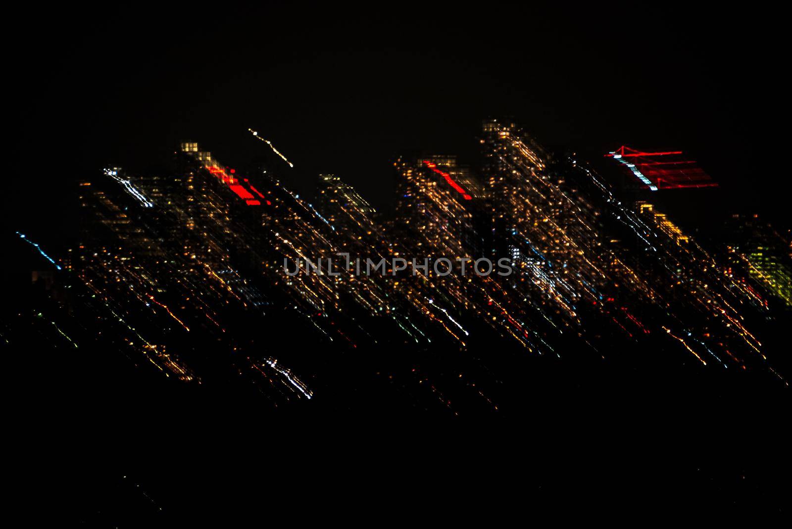 City lights thrown in a night. Abstract lights shift on black background.