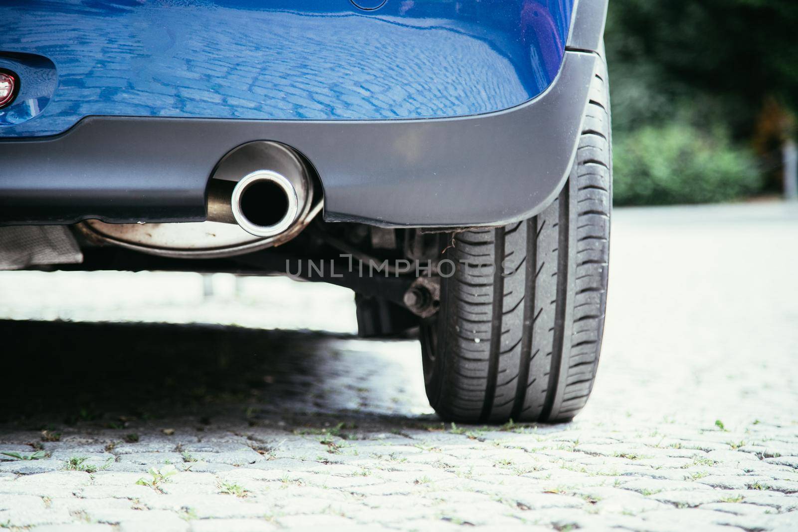 Close up of an exhaust pipe of a car, environmental pollution